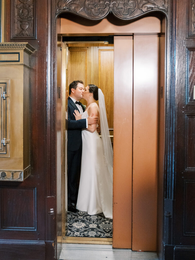 Bride and groom kissing in elevator at westchester country club wedding