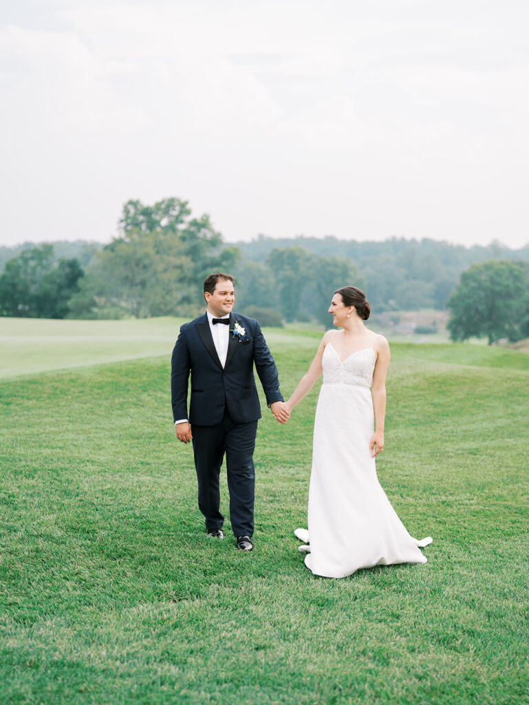 Bride and groom standing on Westchester country club golf course