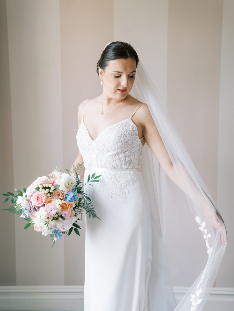 Bride wearing thin strapped sheath wedding gown at westchester country club