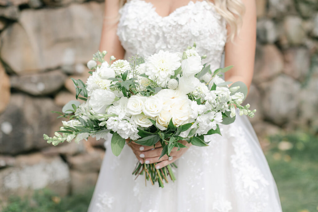 Bride holding a white and off-white bouquet at wedding