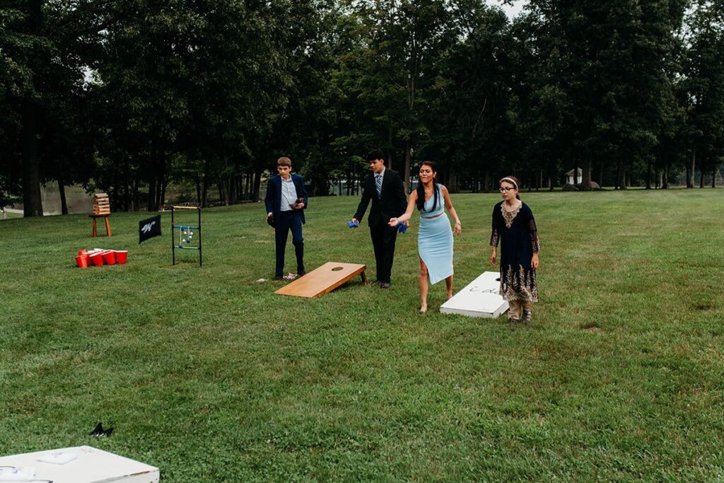 guest playing lawn games at a candlelight farms inn wedding reception