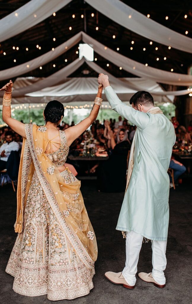 bride and groom in traditional indian wedding attire at connecticut wedding reception